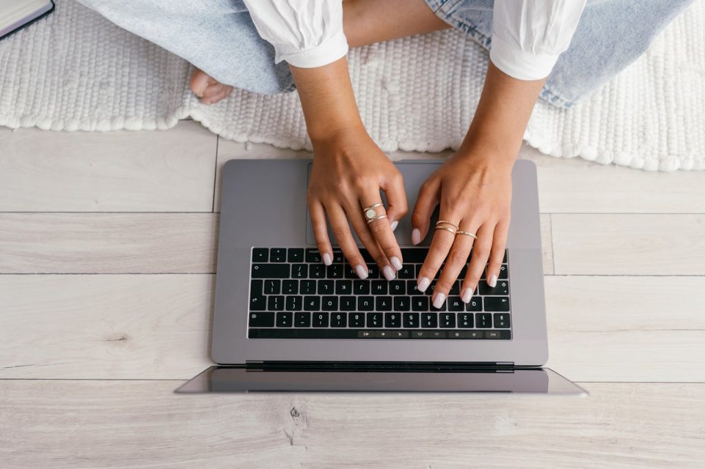 crop-woman-typing-on-laptop-9159409 Unrecognizable woman typing on a laptop, working remotely from home.