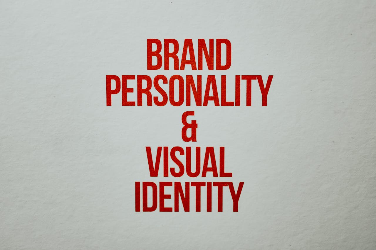 marketing-slogan-on-paper-7661410 Red text emphasizing brand personality and visual identity on a neutral background.